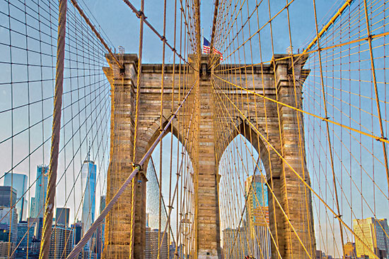 Catch a Star Fine Art STAR241 - STAR241 - Intertwined - 18x12 brooklyn bridge archway, american flag, vertical cables, blue sky, bridge architecture, iconic NYC, evening glow, city landmark, upward view from Penny Lane